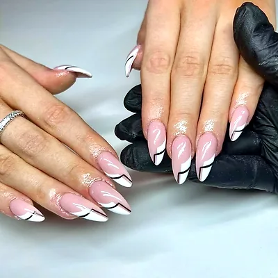 Almond nails in nude and white, each finished with a fine black line